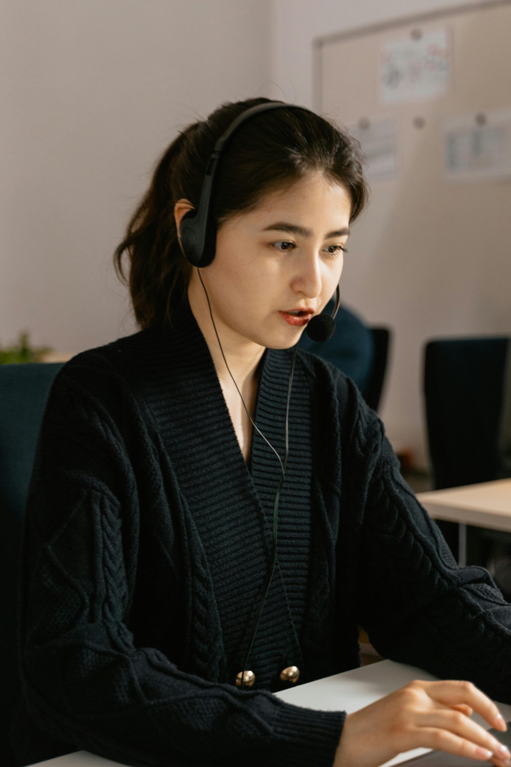 Call center agent with headset providing customer support, focused on work.